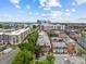 Aerial view showcases the community, nearby buildings, and downtown skyline at 482 New Bern Station Ct, Charlotte, NC 28209