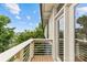 Balcony with wooden floor and white railings overlooking lush greenery at 482 New Bern Station Ct, Charlotte, NC 28209