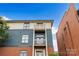 Exterior view showcasing balconies and the blend of brick and siding at 482 New Bern Station Ct, Charlotte, NC 28209