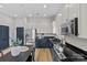 Modern kitchen featuring stainless appliances and stylish two-tone cabinetry with black countertops at 482 New Bern Station Ct, Charlotte, NC 28209