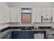 Modern kitchen features a sink and window, stainless steel appliances, and stylish cabinetry at 482 New Bern Station Ct, Charlotte, NC 28209