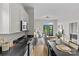 Contemporary kitchen featuring sleek countertops, modern appliances, and a dining area with views of the living space at 482 New Bern Station Ct, Charlotte, NC 28209