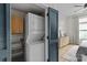 Convenient in-unit laundry with stacked washer and dryer, plus shelving at 482 New Bern Station Ct, Charlotte, NC 28209