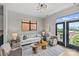 Bright living room with modern lighting, hardwood floors, and balcony access at 482 New Bern Station Ct, Charlotte, NC 28209