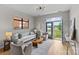 Airy living room with modern lighting, hardwood floors, and access to the balcony at 482 New Bern Station Ct, Charlotte, NC 28209