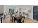 Open-concept living space with modern decor, hardwood floors, and balcony access at 482 New Bern Station Ct, Charlotte, NC 28209