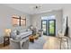 Airy living room with modern lighting, hardwood floors, and access to the balcony at 482 New Bern Station Ct, Charlotte, NC 28209