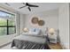Bright main bedroom with hardwood floors, a ceiling fan, and bedside lamps at 482 New Bern Station Ct, Charlotte, NC 28209