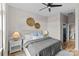 Well-lit main bedroom with hardwood floors, ceiling fan, and side tables at 482 New Bern Station Ct, Charlotte, NC 28209