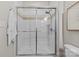Bathroom shower featuring tiled walls with sleek, sliding glass doors at 482 New Bern Station Ct, Charlotte, NC 28209