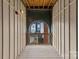 Exterior walkway with an arched opening revealing the courtyard and other buildings at 482 New Bern Station Ct, Charlotte, NC 28209