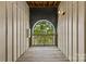 Exterior walkway with an arched opening providing a view of the trees at 482 New Bern Station Ct, Charlotte, NC 28209