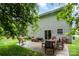 Backyard with a patio, outdoor furniture, grill, and lush landscaping, creating an inviting outdoor space at 4837 Autumn Oak Dr, Charlotte, NC 28269
