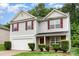 Charming two-story home with red shutters, stone accents and a two car garage in a well-maintained yard at 4837 Autumn Oak Dr, Charlotte, NC 28269