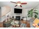 Cozy living room with fireplace, plush seating, a ceiling fan, and hardwood floors at 4837 Autumn Oak Dr, Charlotte, NC 28269