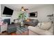 Cozy living room with fireplace, plush seating, a ceiling fan, and hardwood floors at 4837 Autumn Oak Dr, Charlotte, NC 28269