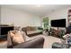 Casual living room features sofas, TV, and natural light at 4837 Autumn Oak Dr, Charlotte, NC 28269