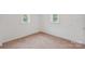 Carpeted bedroom featuring natural light from two windows at 506 N Styers St, Cherryville, NC 28021