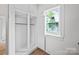 Walk-in closet with built-in shelving and natural light from the window at 506 N Styers St, Cherryville, NC 28021