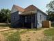 Charming exterior elevation featuring a covered front porch, gray brick, and freshly landscaped yard at 506 N Styers St, Cherryville, NC 28021