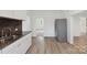 Open-concept kitchen showcasing new stainless steel refrigerator, new counters and light wood flooring at 506 N Styers St, Cherryville, NC 28021