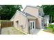 Rear view of a home with a small yard, showing access to the backyard through glass doors at 7046 Dorn Cir, Charlotte, NC 28212