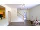 Bright entryway featuring hardwood floors, stairs to the second level, and an open transition to the kitchen at 7046 Dorn Cir, Charlotte, NC 28212