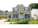 Charming two-story home featuring blue shutters, a welcoming front porch, and a beautifully landscaped front yard at 7046 Dorn Cir, Charlotte, NC 28212