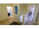 Hallway with wood floors, a view of the study and a bathroom with dark cabinetry at 7046 Dorn Cir, Charlotte, NC 28212