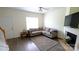 Comfortable living room featuring hardwood floors, a cozy sectional sofa, and a fireplace at 7046 Dorn Cir, Charlotte, NC 28212