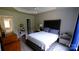 Serene bedroom with tray ceiling, features a comfortable bed, soft lighting, and wood flooring at 7046 Dorn Cir, Charlotte, NC 28212