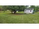 Beautifully landscaped backyard with a shed, providing ample storage and outdoor space at 804 N Main St, Oakboro, NC 28129