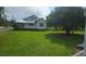 The property features a spacious green lawn, mature trees and blue sky perfect for enjoying outdoor activities at 804 N Main St, Oakboro, NC 28129
