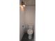 Small toilet in an enclosed room features white paneling at 804 N Main St, Oakboro, NC 28129