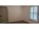 Bedroom featuring horizontal wall paneling, a window with plantation shutters and hard surface floors at 804 N Main St, Oakboro, NC 28129