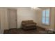 Bedroom featuring horizontal wall paneling and a modern window with plantation shutters at 804 N Main St, Oakboro, NC 28129