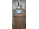Attic bedroom with windows, ceiling fan, and wood-look walls at 804 N Main St, Oakboro, NC 28129