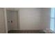 Bedroom featuring horizontal wall paneling, a window with plantation shutters and hard surface floors at 804 N Main St, Oakboro, NC 28129