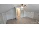Bright bedroom with ceiling fan, wood-look walls, and closet at 804 N Main St, Oakboro, NC 28129