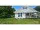 Charming home with white siding, metal roof, black shutters, and manicured lawn at 804 N Main St, Oakboro, NC 28129