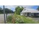 Quaint home exterior with well-maintained lawn, garden and chain link fence at 804 N Main St, Oakboro, NC 28129