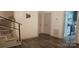 Entryway featuring staircase, wood-look walls, and dark hardwood flooring at 804 N Main St, Oakboro, NC 28129
