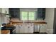 Updated kitchen featuring butcher block counters, stainless steel appliances, and updated cabinets at 804 N Main St, Oakboro, NC 28129