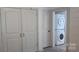 Bright laundry area features a stacked washer and dryer for space-saving convenience at 804 N Main St, Oakboro, NC 28129