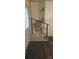Carpeted stairs with modern black railing and dark hardwood flooring at 804 N Main St, Oakboro, NC 28129