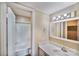Bright bathroom featuring a large mirror and vanity with a view into the tub and shower at 809 High Meadow Ln # F, Charlotte, NC 28217