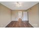 This bedroom offers neutral walls and flooring, and access to an en-suite bathroom and closet at 809 High Meadow Ln # F, Charlotte, NC 28217