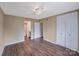 This bedroom features hardwood floors, neutral paint, a ceiling fan, and spacious closet for ample storage at 809 High Meadow Ln # F, Charlotte, NC 28217