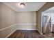 Dining area features wood-look flooring, and a stainless steel refrigerator at 809 High Meadow Ln # F, Charlotte, NC 28217