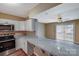 Spacious kitchen featuring gray countertops and stainless steel appliances at 809 High Meadow Ln # F, Charlotte, NC 28217